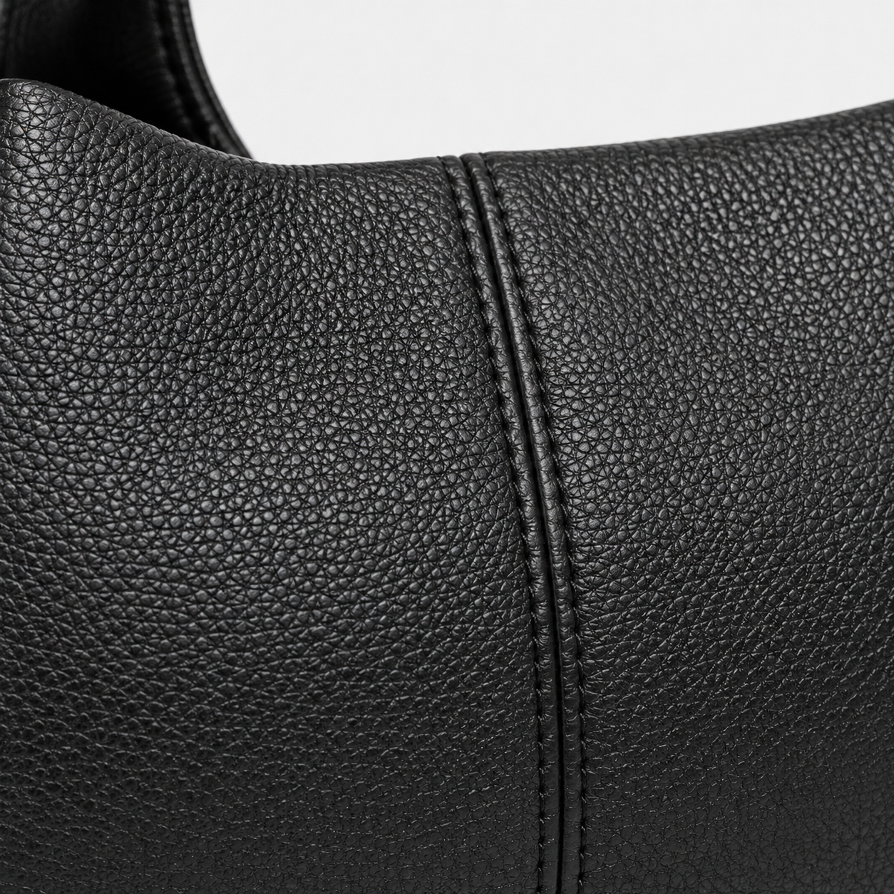 Close-up of La Luna top-grain cowhide, natural texture and stitching.