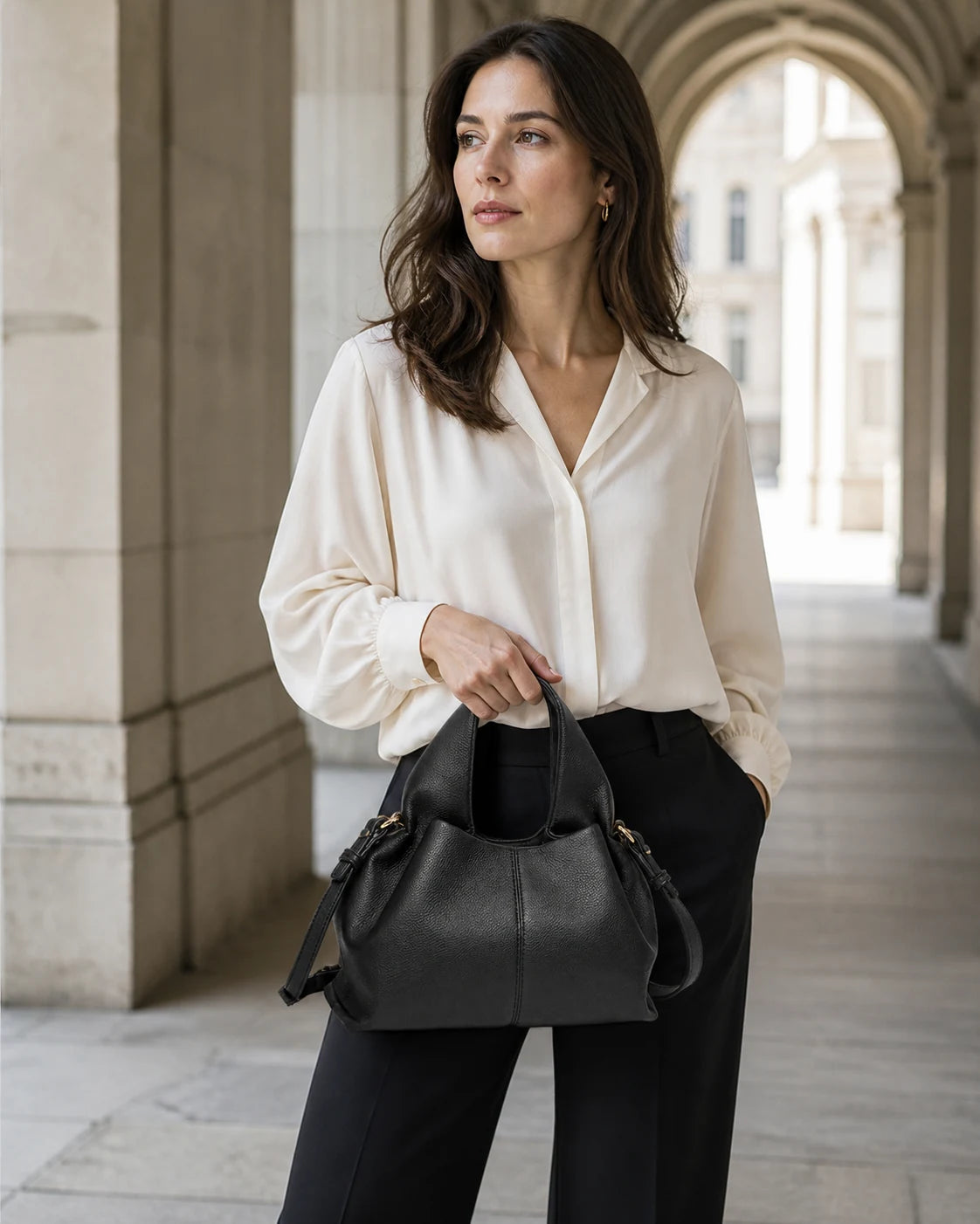 La Luna genuine leather shoulder bag carried in a quiet-luxury Zurich setting.