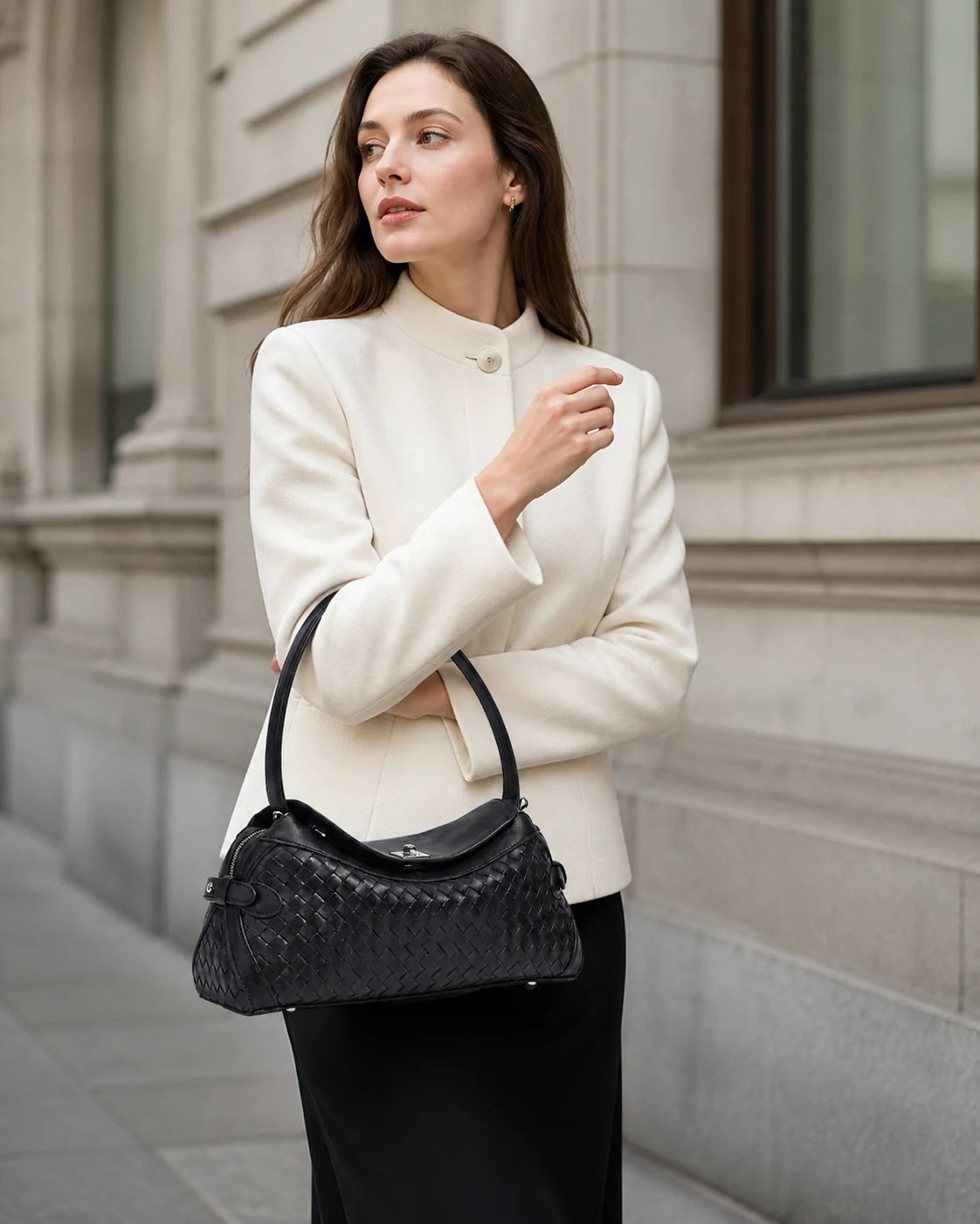 La Trecciata woven leather shoulder bag carried in a refined Zurich setting.
